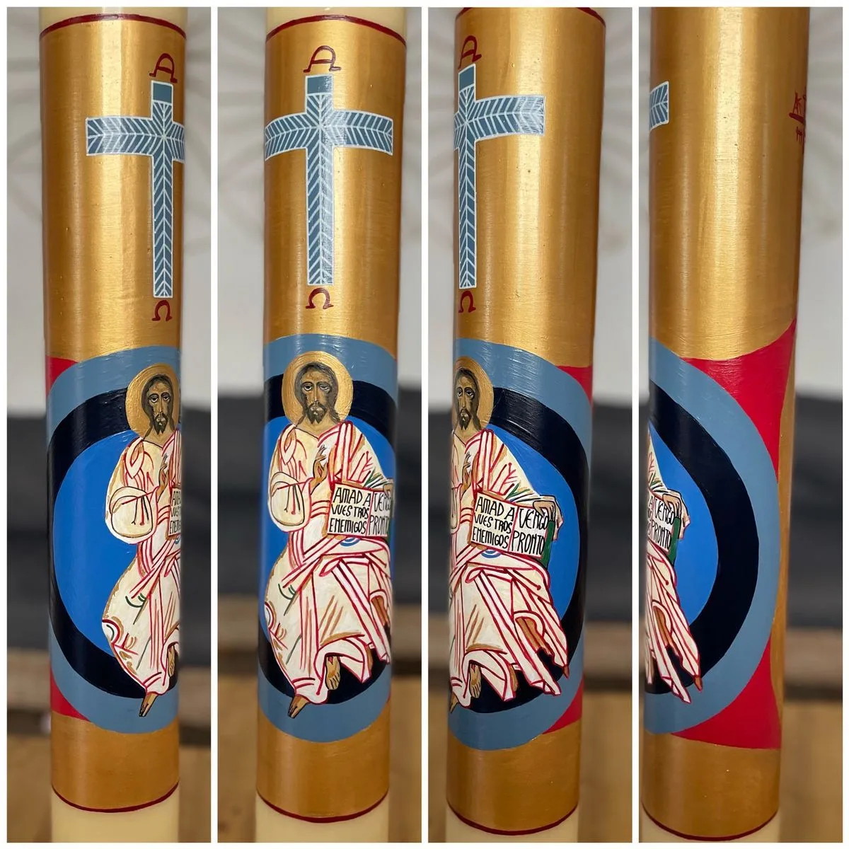 Detalle de un cirio pascual pintado a mano con Cristo y la inscripción «Amad a vuestros enemigos»